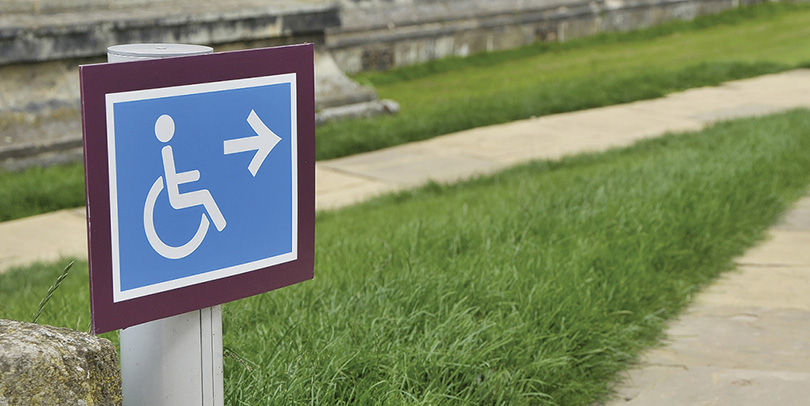Directional sign for disabled travelers