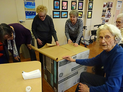 Adult Day participants creating donation boxes