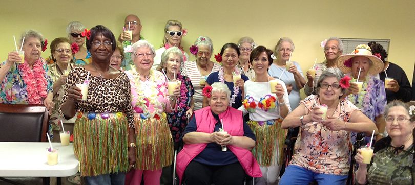 Laurie Peters and senior housing residents celebrate Hawaiian style
