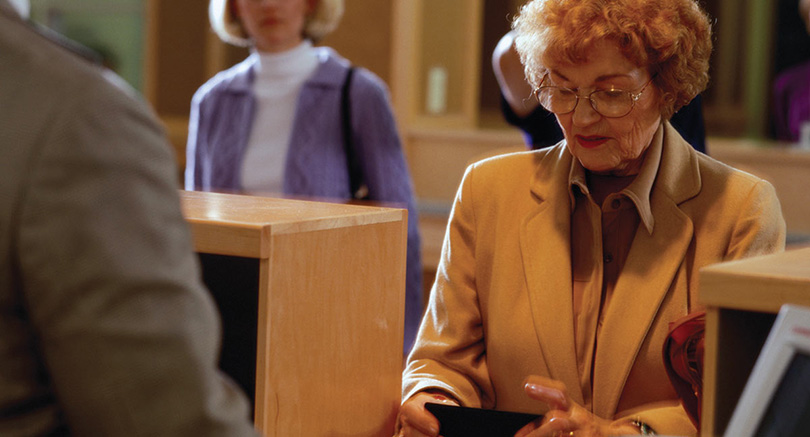 Older woman with a bank teller