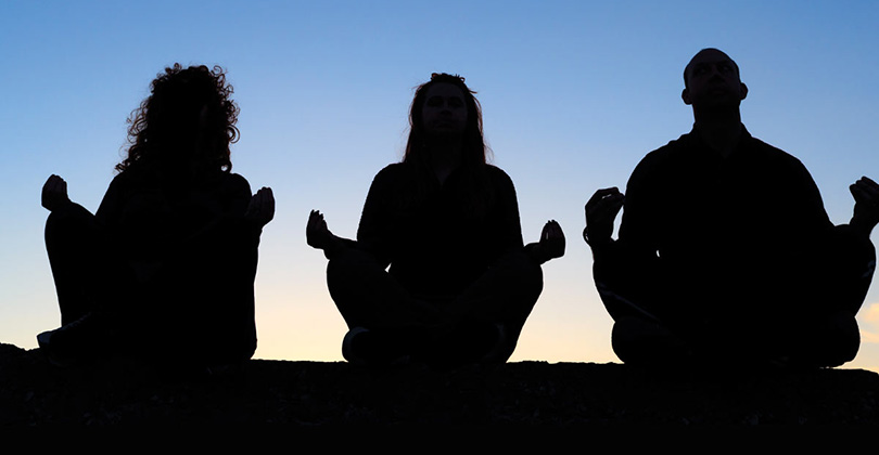 3 people meditating